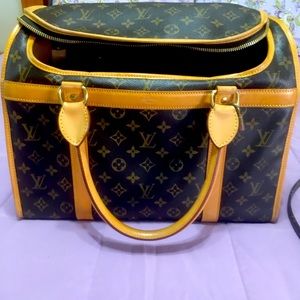 Louis Vuitton animal carrier with leash.